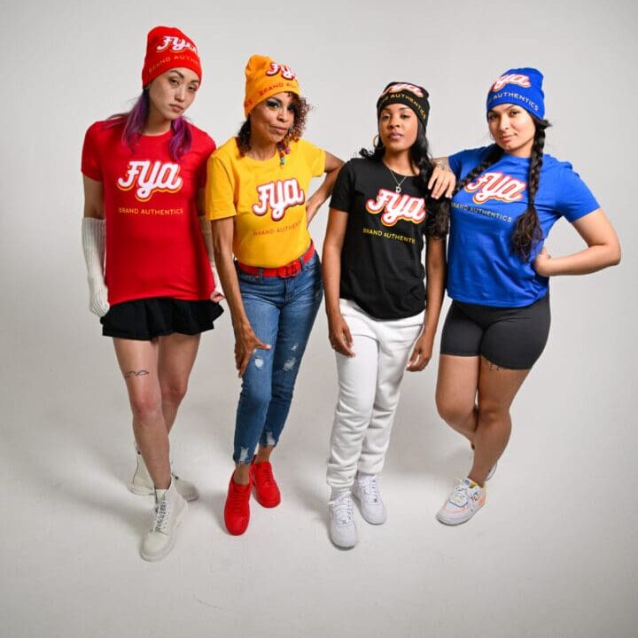Four women in colorful sporty outfits posing against a white background.